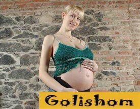 Pregnant blonde at home