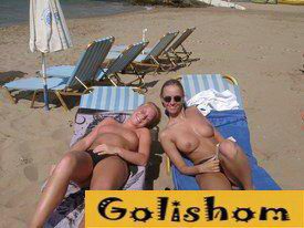Nudist girls frolic on the beach