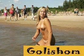 A pretty nudist undressed on a public beach