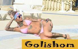 Tattooed Gemma Lucy lit up in a bikini by the pool