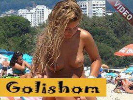 Gorgeous girl sunbathing topless on a nude beach-video